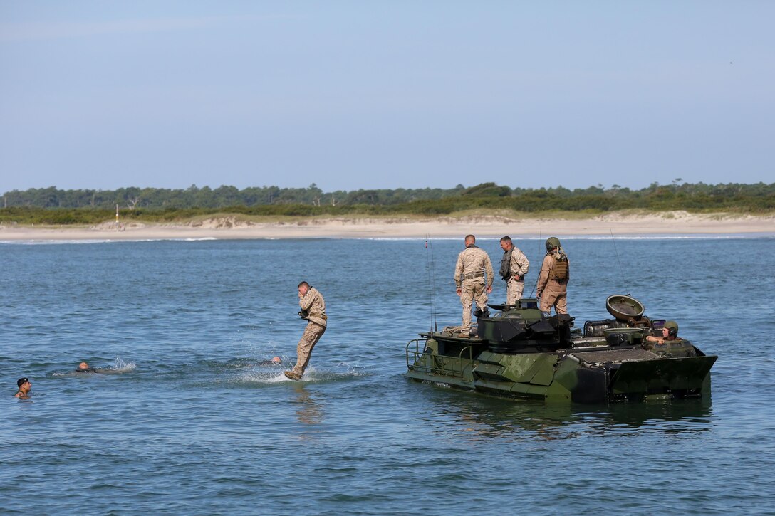 A Marine with 2nd Assault Amphibian Battalion, 2nd Marine Division jumps off an amphibious assault vehicle during their annual surf qualification Sept. 12, 2013 at Onslow Beach aboard Marine Corps Base Camp Lejeune. Marines were taken 500 meters off-shore before evacuating the AAV.