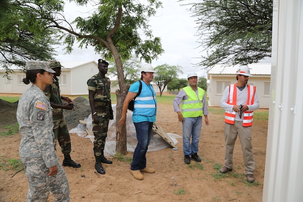 Representatives from the Senegalese armed forces, U.S. Embassy Senegal, U.S. Army Corps of Engineers Europe District and contractor, CNaf-SET, tour the Dodji Peace Keeping Operations Training Center project site Aug. 20 in Senegal. The camp is being upgraded to include eight new barracks, a dining facility, shower and latrine facilities for men and women, a water treatment plant and a well. The turnkey facilities will accommodate and supply 1,000 soldiers upon completion mid-September. U.S. Department of State Global Peace Operations Initiative funded the project to support the development of Senegalese PKO capabilities.