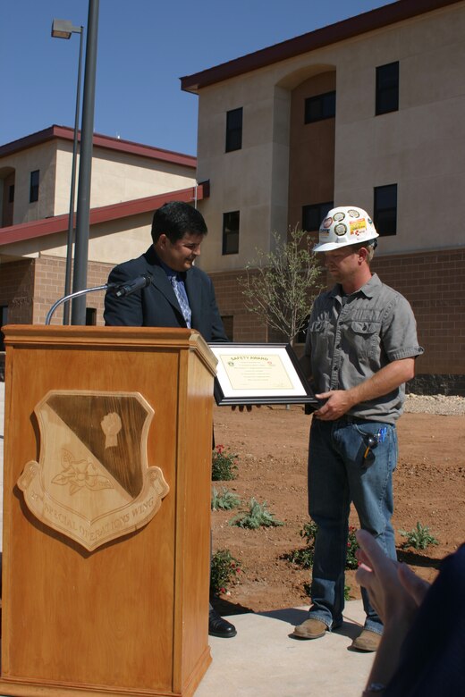 CANNON AIR FORCE BASE, N.M. – John Moreno, the District’s chief of Engineering and Construction, presents the contractor, Charpie Korte, a safety award Sept. 6, 2013, for “no recordable or lost time accidents” during the entire course of construction under their contract. This is in excess of 110,000 man-hours without incident.