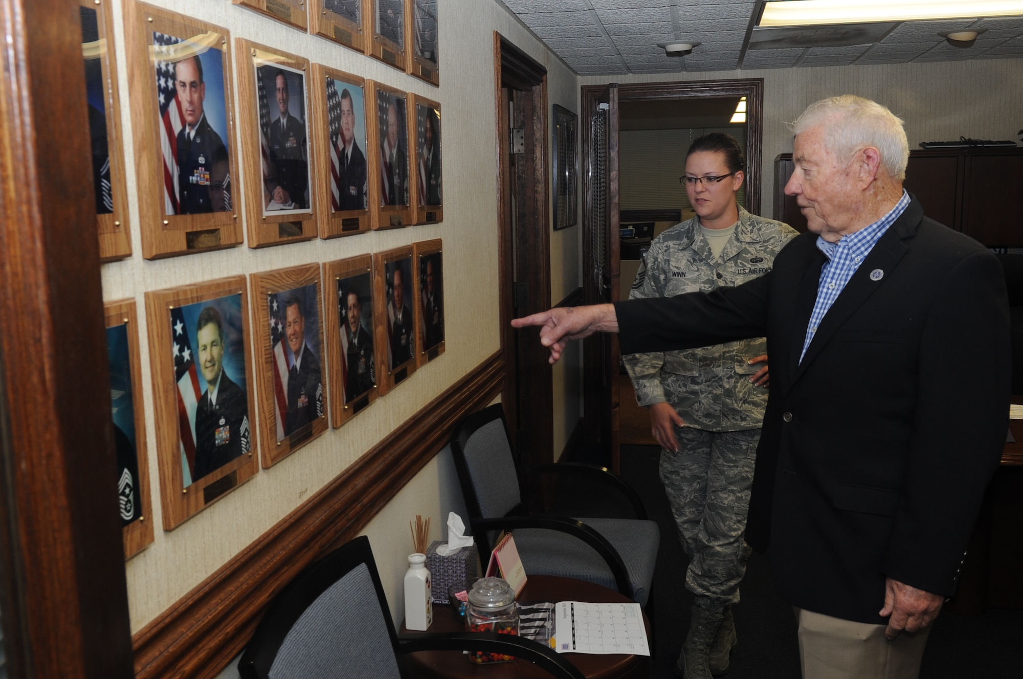 Retired Chief Master Sgt. of the Air Force Robert Gaylor looks at pictures of former chiefs who also held his title, with Master Sgt. Amy Winn, Pacific Air Forces Command Chief executive, during his visit Sept. 13, 2013, to Joint Base Pearl Harbor-Hickam, Hawaii. During Gaylor's trip, September 11 through 14, he shared his experiences and insight with Airmen at a junior enlisted call, First Term Airmen Center, Airmen Leadership School, Top III senior non-commission officer group, and Air Force Ball participants.  