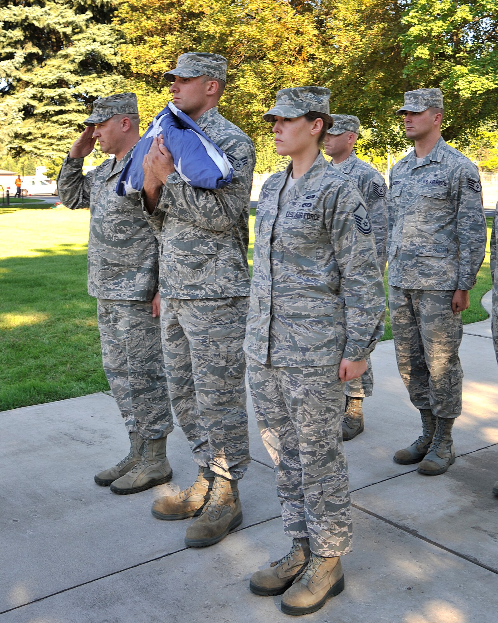 Members of Team Fairchild prepare to retire a flag during a retreat ceremony at Fairchild Air Force Base, Wash., Sept. 11, 2013. This ceremony was held in rememberance of the Sept. 11 tradegy 12 years ago. (U.S. Air Force photo by Senior Airman Mary O'Dell/Released)