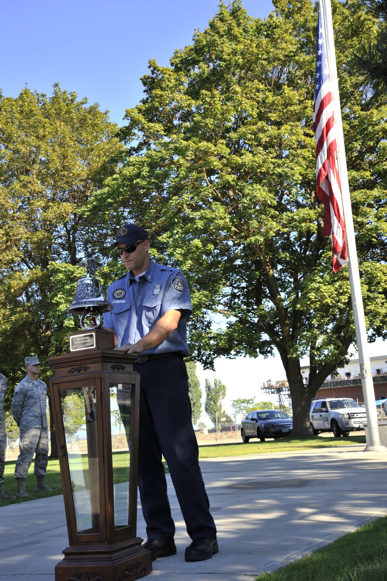 Kris Maynard, 92nd Civil Engineer Squadron lead firefighter, rings a ceremonial firefighter's bell at a retreat ceremony at Fairchild Air Force Base, Wash., Sept. 11, 2013. Traditionally three bells are sound in rememberance of those who can no longer respond to the call due to the Sept. 11 tradegy 12 years ago. (U.S. Air Force photo by Senior Airman Mary O'Dell/Released)