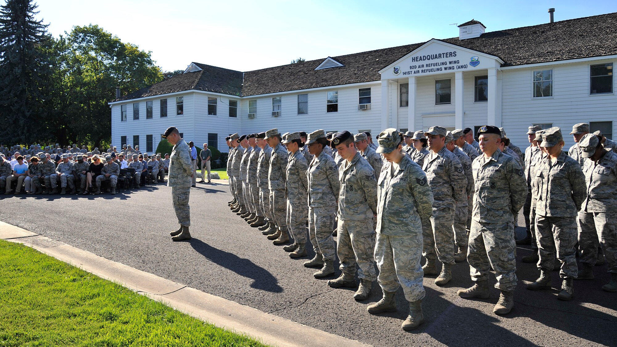 Members of Team Fairchild listen to the invocation before a retreat ceremony at the Wing Headquarters building at Fairchild Air Force Base, Wash., Sept. 11, 2013. The ceremony was done in rememberance of the Sept. 11 tradegy 12 years ago. (U.S. Air Force photo by Senior Airman Mary O'Dell/Released)