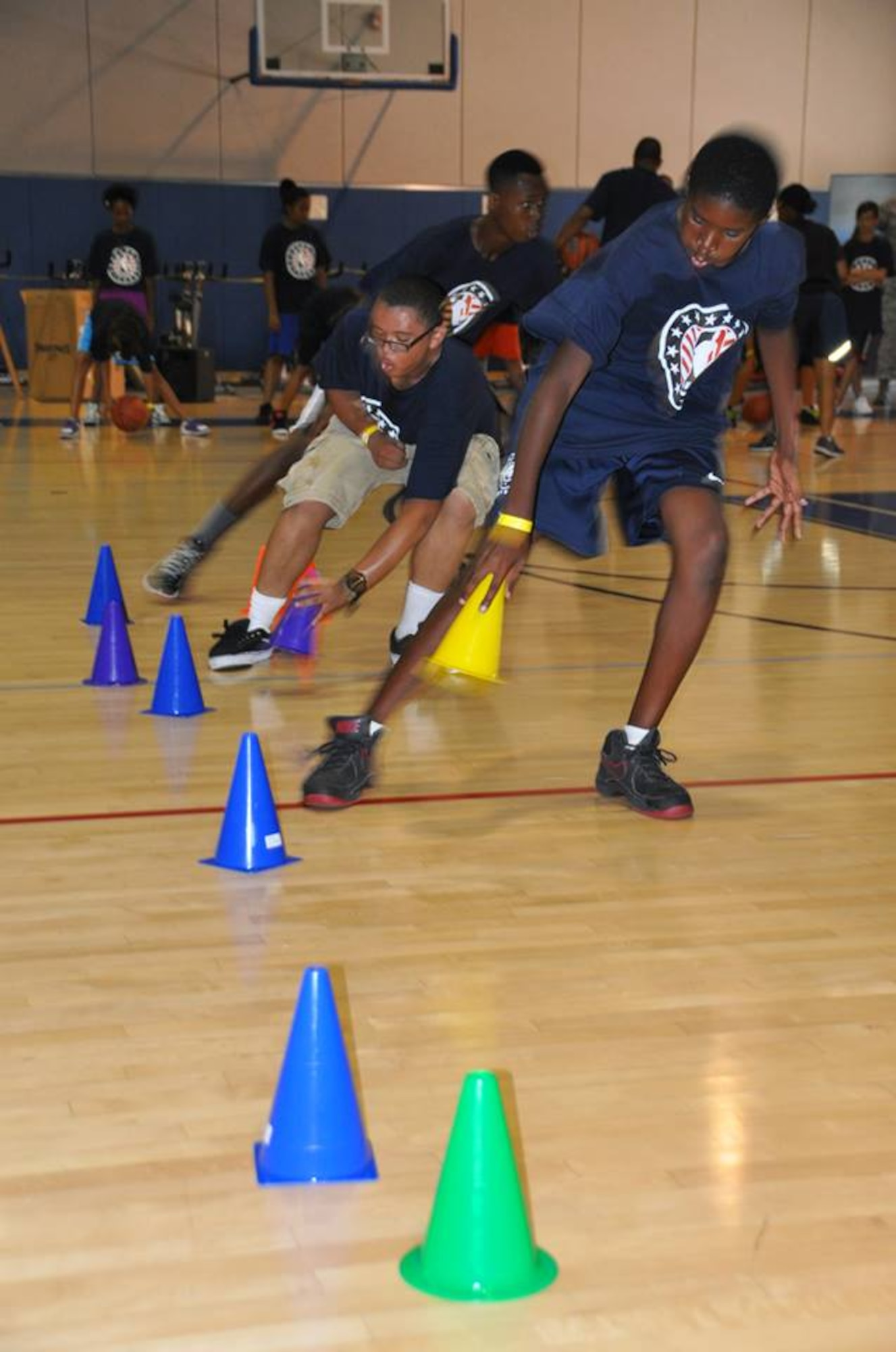 Military dependents race through a basketball drill at March Air Reserve Base, Calif., during the NBA Cares Hoops for Troops basketball clinic Sunday, Sept. 8, 2013. The NBA Cares program sponsored the event in conjunction with the Healthy Base Initiative kickoff. (U.S. Air Force photo/Master Sgt. Linda Welz)