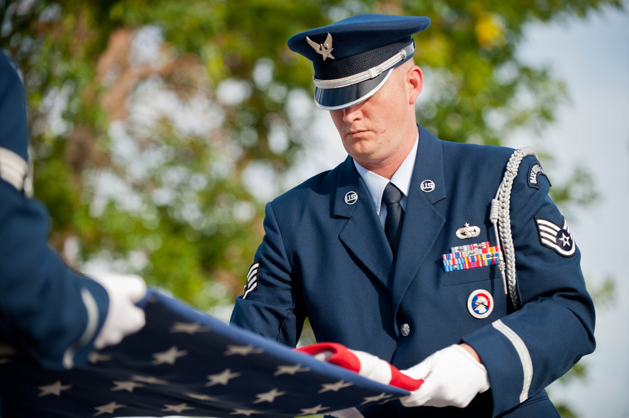 Staff Sgt. Bobby Pantfoader, 28th Force Support Squadron base Honor Guardsman, folds the flag during the 9/11 Remembrance Retreat ceremony in front of the 28th Bomb Wing Headquarters at Ellsworth Air Force Base, S.D., Sept. 11, 2013. The retreat signified to relatives, friends and colleagues of the fallen that the sacrifices of their loved ones will never be forgotten. (U.S. Air Force photo by Airman 1st Class Zachary Hada/Released)