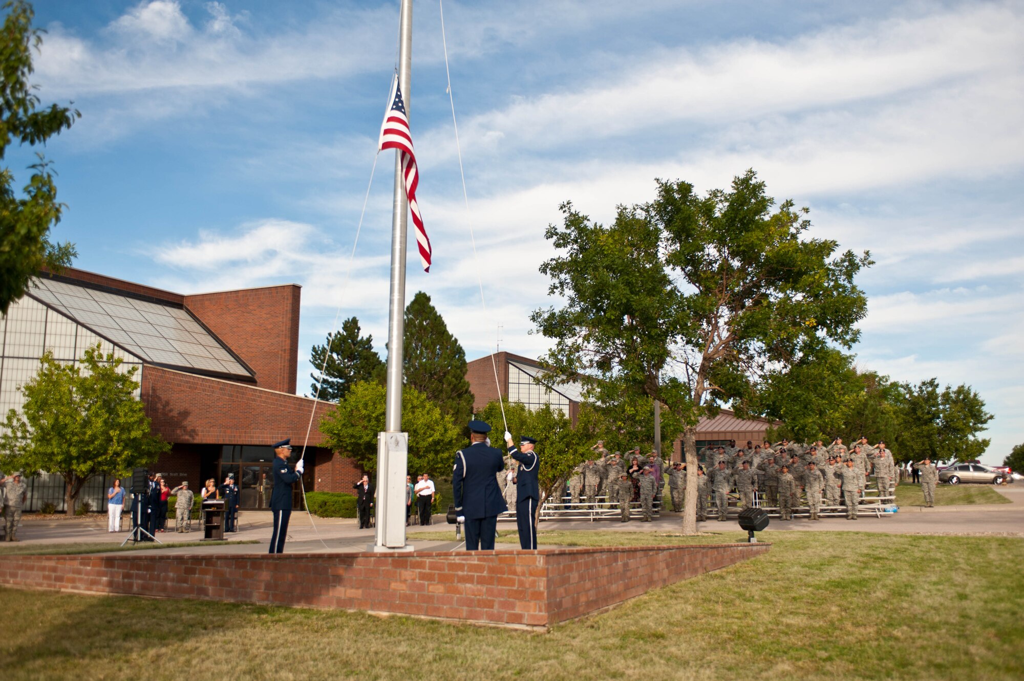 Airmen from the base Honor Guard fold a U.S. flag during the 9/11 Remembrance Retreat ceremony in front of the 28th Bomb Wing Headquarters at Ellsworth Air Force Base, S.D., Sept. 11, 2013. The ceremony was held to commemorate lives lost in war-time and during the terrorist attack on Sept. 11, 2001. (U.S. Air Force photo by Airman 1st Class Zachary Hada/Released)