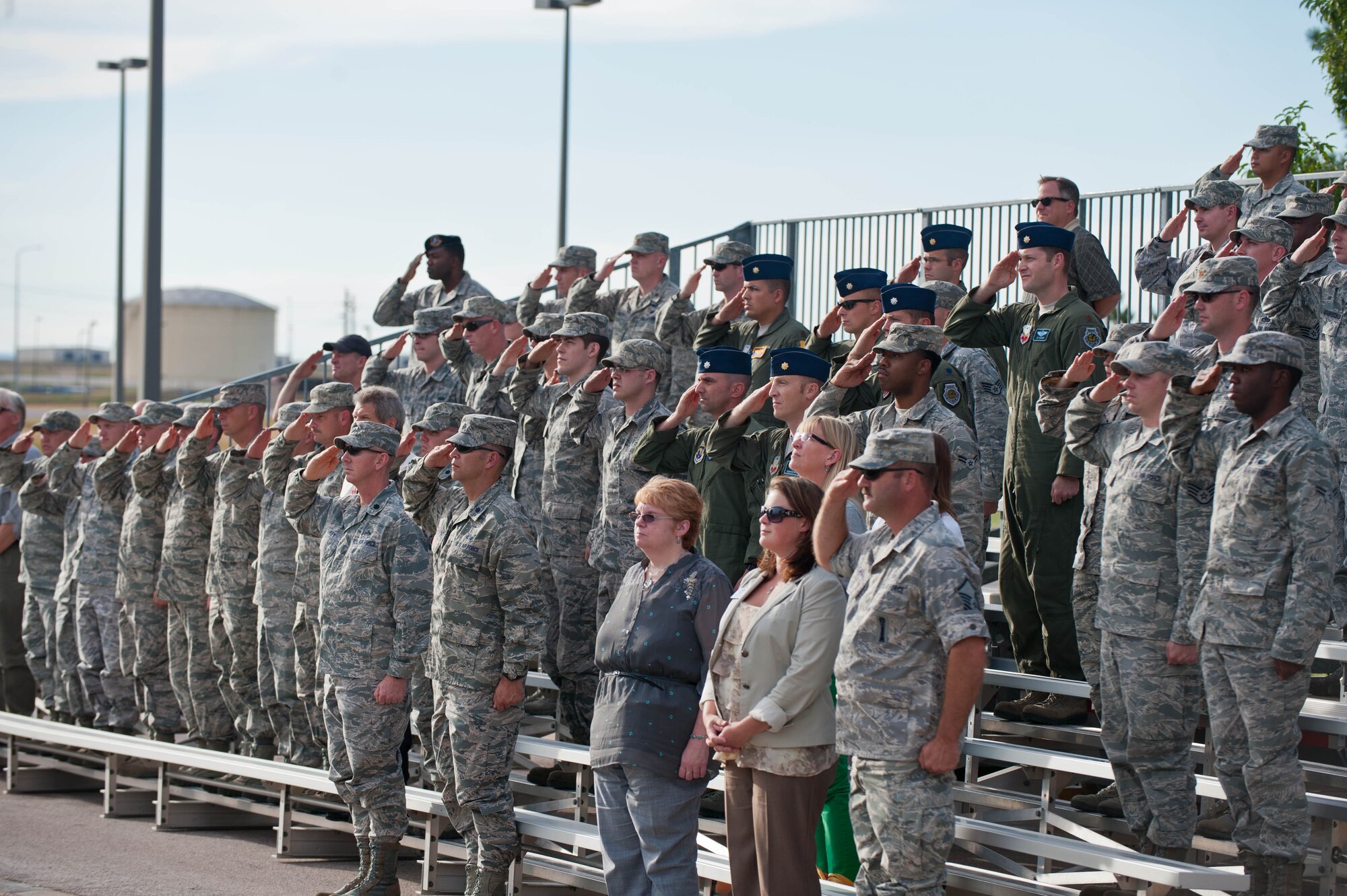 Airmen, family members and civilians pay respect to the U.S. flag during the 9/11 Remembrance Retreat ceremony in front of the 28th Bomb Wing Headquarters at Ellsworth Air Force Base, S.D., Sept. 11, 2013. The event included remarks by Col. Kevin Kennedy, 28th BW commander, and a retreat ceremony conducted by the base Honor Guard. (U.S. Air Force photo by Airman 1st Class Zachary Hada/Released)