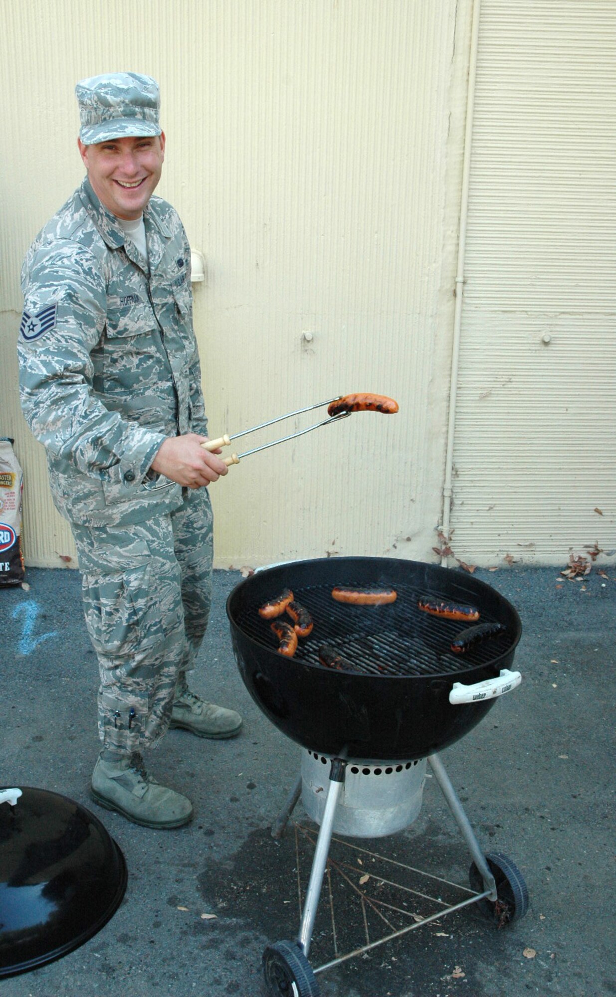 Staff Sgt. Jason P. Hoffman, 50th Intelligence Squadron mission systems supervisor, shows off his grilling skills during the 12th Day celebration Friday at Beale AFB, Calif. Reservists assigned to the 50 IS, celebrate the upcoming weekend after working 12 days in a row Friday.  This celebration, formally called 12th Day, was conceived in April to signify the end to a long work schedule.  12th Day was started by Reservists but is open to active-duty servicemembers and civilian employees.  This event is a time for everyone to come together, build camaraderie and enjoy some great food.  (U.S. Air Force photo/Senior Airman Bobby Pilch - released)
