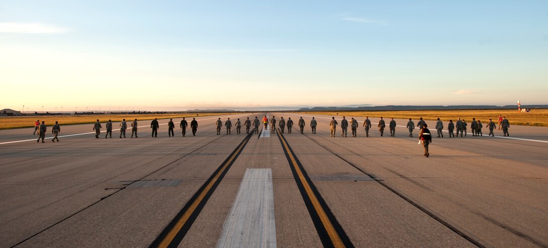 Dyess Airmen conduct a Foreign Object Debris (FOD) walk down the flightline Sept. 9, 2013, at Dyess Air Force Base, Texas. On Aug. 29, Dyess reached a new pinnacle of FOD prevention; 1,500 days without a chargeable FOD incident. FOD is considered a substance, debris or article alien to a vehicle or system which can cause significant damage. The Wing FOD management office hosts monthly FOD walks to minimize possible damage to aircraft from debris. (U.S. Air Force photo by Staff Sgt. Richard Ebensberger/Released)