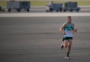 Ensign Matthew DeVillers, Navy Nuclear Power Training Command, runs on the flight line during the “Run the Runway 5k” Sept. 13, 2013, at Joint Base Charleston – Air Base, S.C. This was the first time that "Run the Runway" was used as a commander's challenge and the run brought in over 700 Joint Charleston participants. The event was held to celebrate the delivery of the last U.S. Air Force C-17 to Joint Base Charleston. (U.S. Air Force photo/Tech. Sgt. Rasheen Douglas)