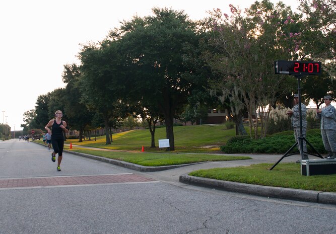 Kate Hoffman, Joint Base Charleston military dependent, is the first female to cross the finish line in 21:07 during the "Run the Runway 5k" Sept. 13, 2013 at Joint Base Charleston, S.C. This is the first time that "Run the Runway" was used as a commander's challenge and the run brought in over 700 Joint Base Charleston participants. (U.S. Air Force photo/Senior Airman Ashlee Galloway)