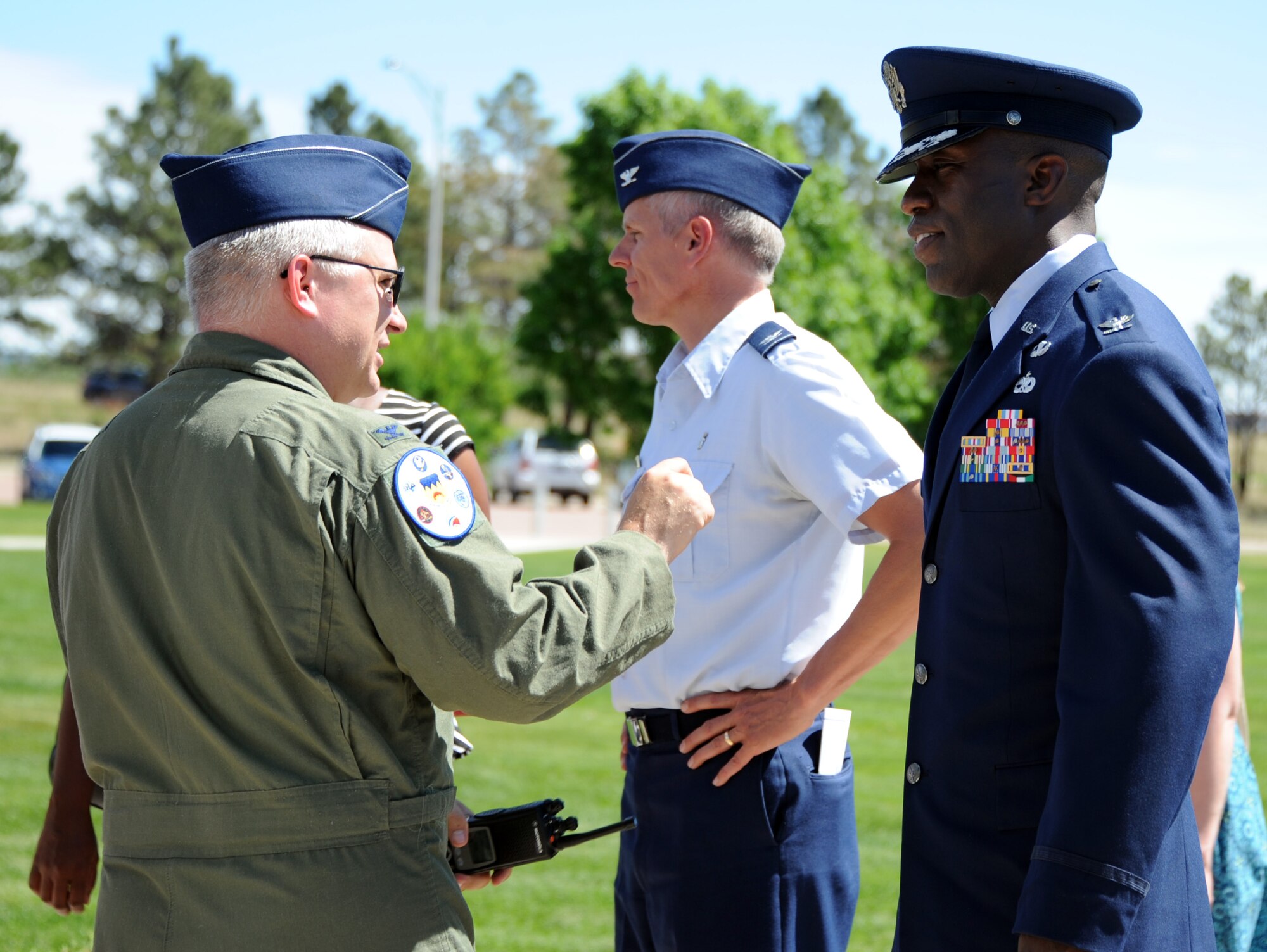 Col. Stacey Hawkins (right) talks with friends and family after accepting command of the 10th Air Base Wing June 10 at the wing headquarters building. (U.S. Air Force Photo/Carol Lawrence)