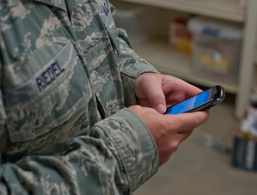 U.S. Air Force Master Sgt. Kelly Riedel, 366th Medical Group first sergeant, holds his phone, Aug 20, 2013 at Mountain Home Air Force Base, Idaho. Riedel, like other first sergeants, are on call 24/7 in case an emergency happens. (U.S. Air Force photo by Airman 1st Class Brittany Chase/Released)