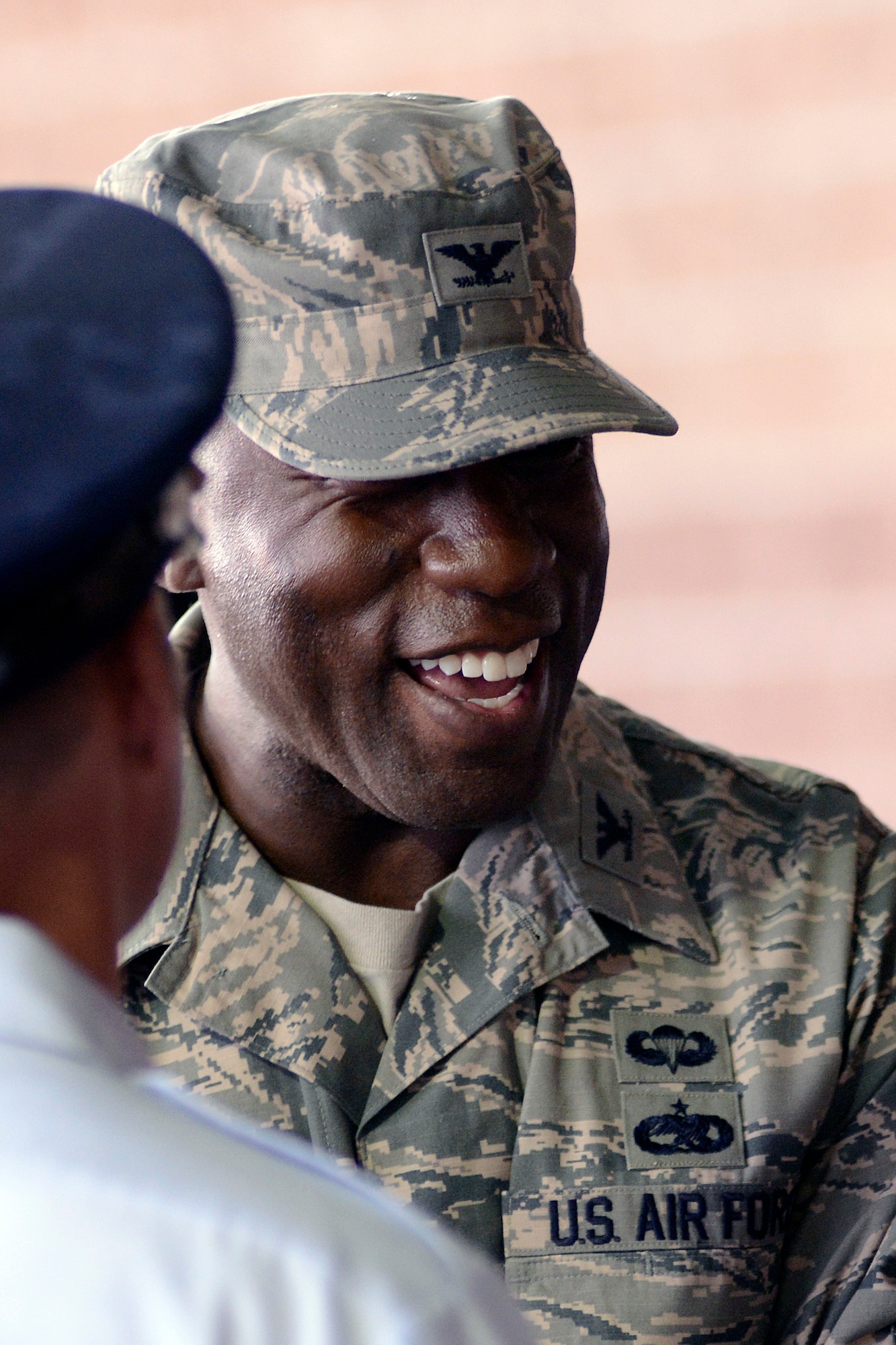 Col. Stacey Hawkins shares a laugh with a member of the U.S. Air Force Academy Band during a baseball game Aug. 22. Hawkins is the 10th Air Base Wing commander for the U.S. Air Force Academy.  (U.S. Air Force Photo/Mike Kaplan)