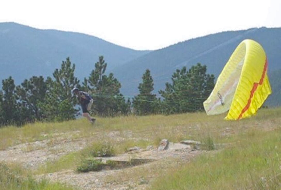 Steve Hovis, a paraglider, prepares his glider aircraft for a forward launch in Dayton, W.Y., Aug. 16, 2013. Seconds into his flight, Hovis lost control of his glider and crashed into a ravine. (Courtesy photo by Steve Hovis)