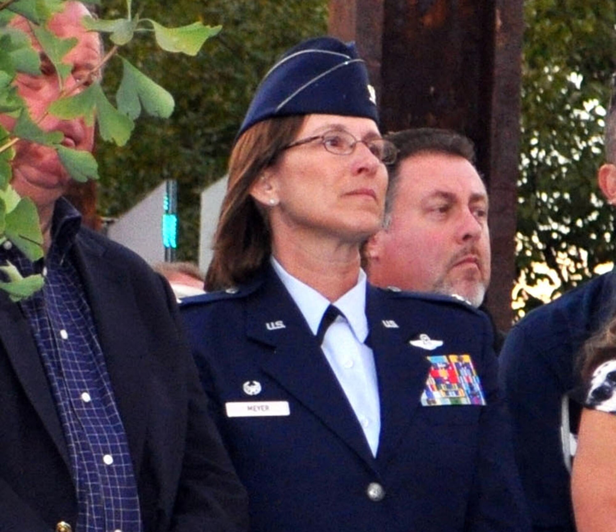 TRAVIS AIR FORCE BASE, Calif. -- Col. Ruth Meyer and her Honorary Commander, Napa Council member Bill Dodd, to her right, listen to a speaker at the Napa 9-11 Memorial Garden dedication, on the twelfth anniversary of the terrorist attack on America. Four of the steel beams from the World Trade Center stand in stark witness behind them, as part of the sculptural elements created by Napa artist, Gordon Huether. Meyer most recently was the reservist Commander of the 349th Operations Support Flight at Travis AFB, and has been selected to be the individual mobilization augmentee to the two star commander of The Air Force Safety Center, Kirtland AFB, N.M. (U.S. Air Force photo/Ellen Hatfield)