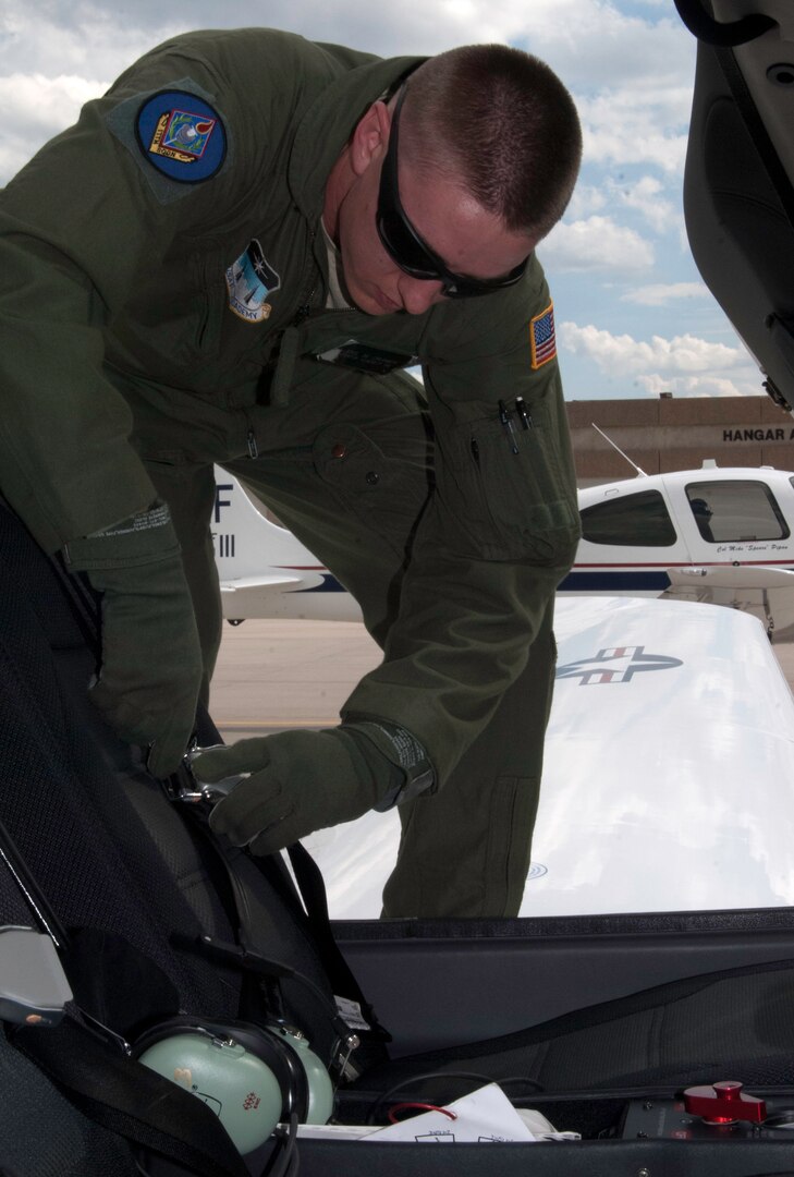 Cadet 2nd Class Joel Cramer climbs into the pilot’s seat of a T-53 training aircraft at the Academy Sept. 9. (U.S. Air Force Photo/Don Branum)