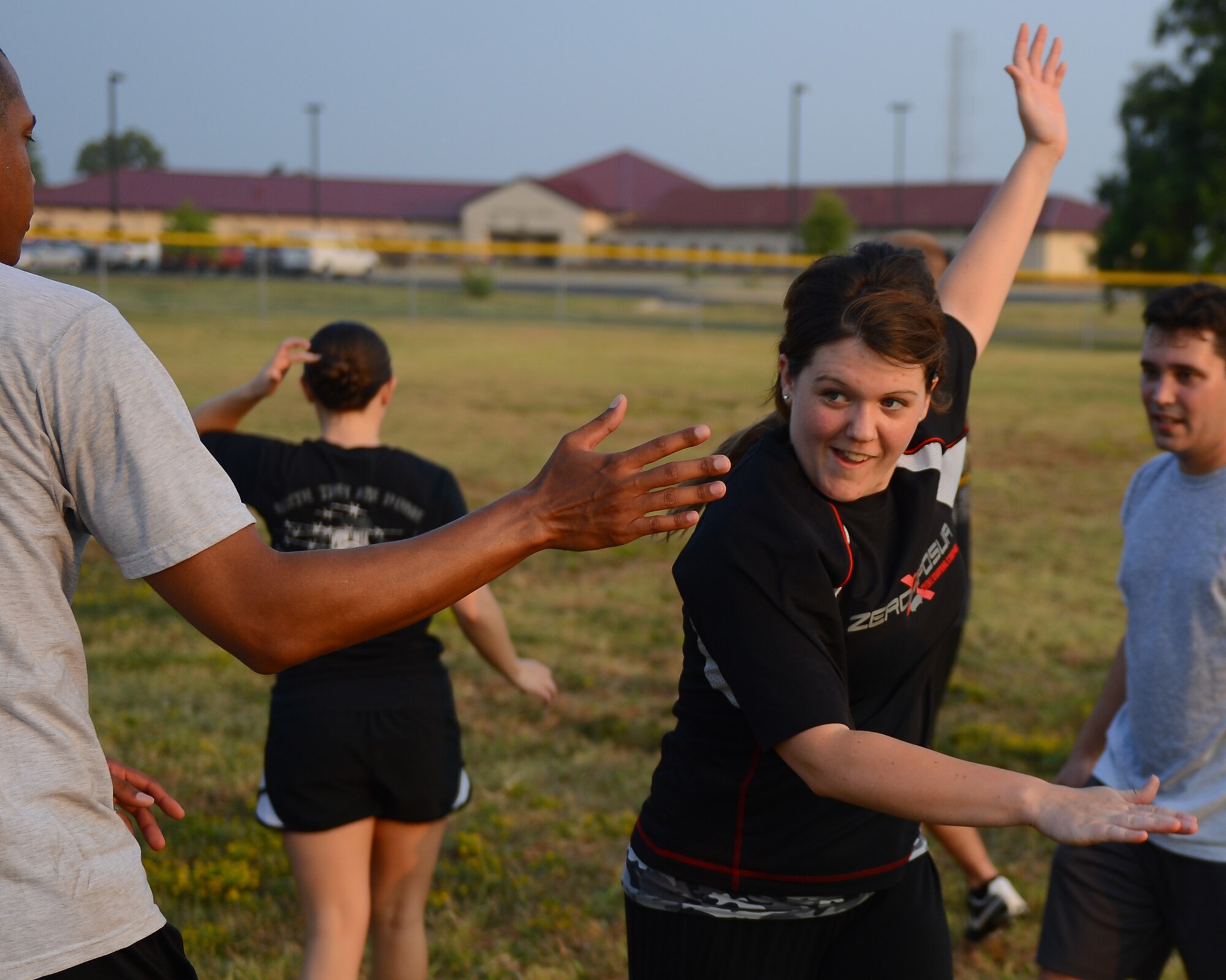 Airman 1st Class Jasmine Rieberger high-fives Senior Airman Jeffrey Hairston, 2nd Contracting Squadron contracting specialists, on Barksdale Air Force Base, La., Sept. 13, 2013. The Airmen played ultimate football as a part of Wingman Week. Wingman Week is a base-wide initiative for Airmen to come together, get to know each other better and discuss ways to become more resilient. (U.S. Air Force photo/Senior Airman Micaiah Anthony)
