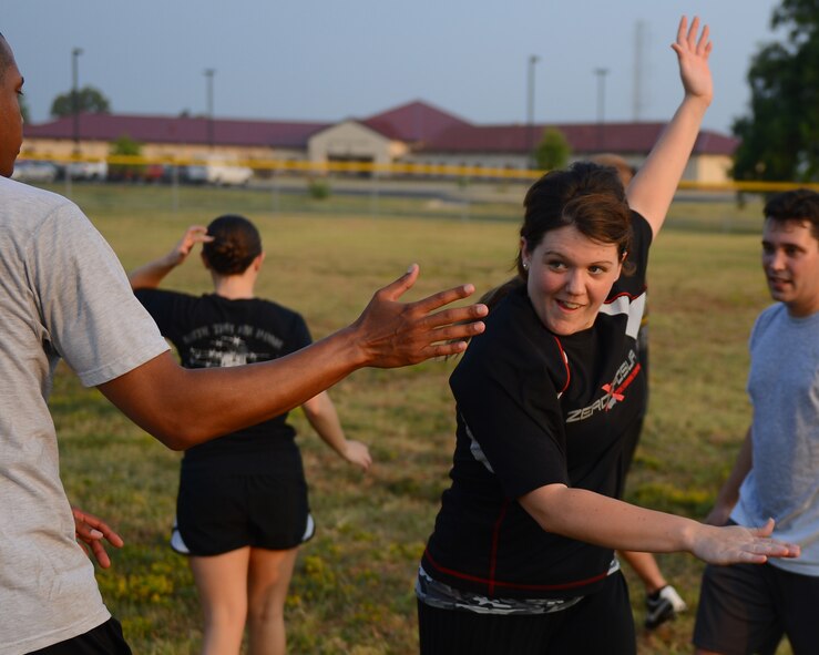 Airman 1st Class Jasmine Rieberger high-fives Senior Airman Jeffrey Hairston, 2nd Contracting Squadron contracting specialists, on Barksdale Air Force Base, La., Sept. 13, 2013. The Airmen played ultimate football as a part of Wingman Week. Wingman Week is a base-wide initiative for Airmen to come together, get to know each other better and discuss ways to become more resilient. (U.S. Air Force photo/Senior Airman Micaiah Anthony)