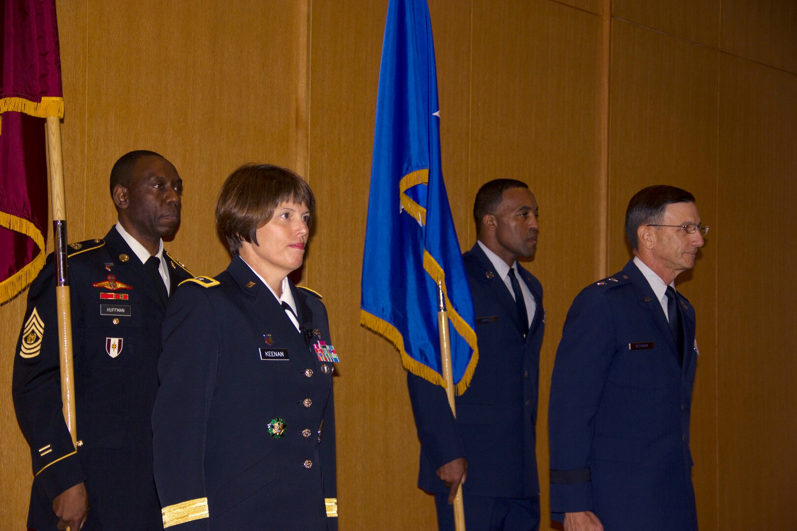 In a ceremony held at San Antonio Military Medical Center, Army Maj. Gen. Jimmie O. Keenan, front left, assumed authority as the director of the San Antonio Military Health System from Air Force Maj. Gen. Byron C. Hepburn, front right, who will now serve as the deputy director. During the transfer of authority, the senior enlisted advisors, Army Command Sergeant Major Marshall L. Huffman, back left, and Air Force Chief Master Sergeant Maurice A. James, back right, follow the generals as they trade places, symbolically marking the transfer of leadership from Air Force to Army.  (U.S. Army photo by Erin Perez/Released)