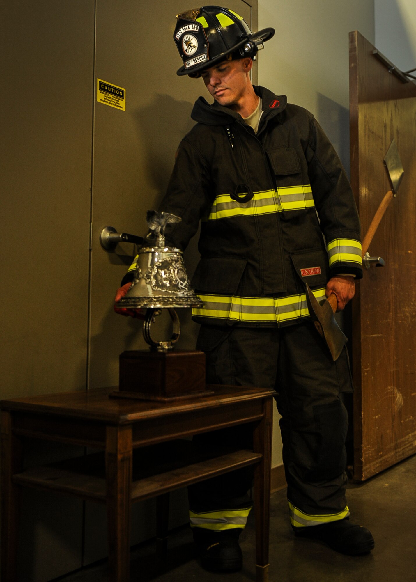 Staff Sgt. Zach Colburn, a 19th Civil Engineer Squadron firefighter, rings a bell 12 times in remembrance of the emergency responders who gave their lives 12 years ago Sept. 11, 2013, at Little Rock Air Force Base, Ark.  Congress designated Sept. 11 as a National Day of Service and Remembrance. (U.S. Air Force photo by Airman 1st Class Cliffton Dolezal)