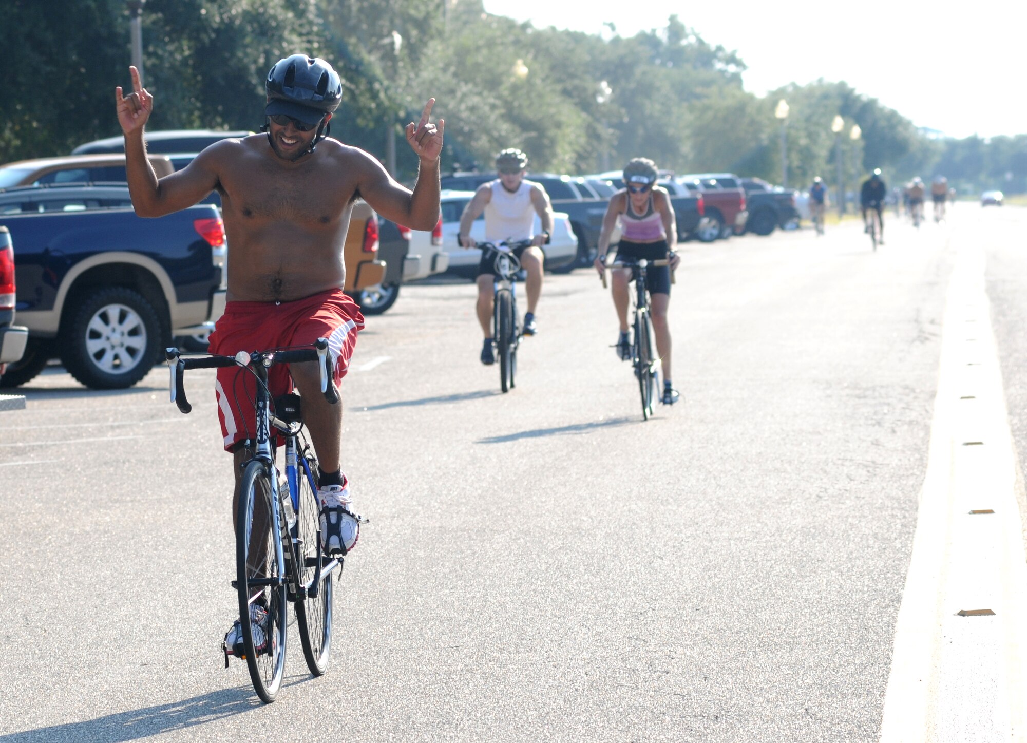 Miguel Rivera-Ainaga, Keesler life guard, completes the 9-mile bike ride during Keesler's mini-triathlon Sept. 13, 2013, at Keesler Air Force Base, Miss.  The event also included a 2-mile run and a 200-yard swim.  (U.S. Air Force photo by Kemberly Groue)