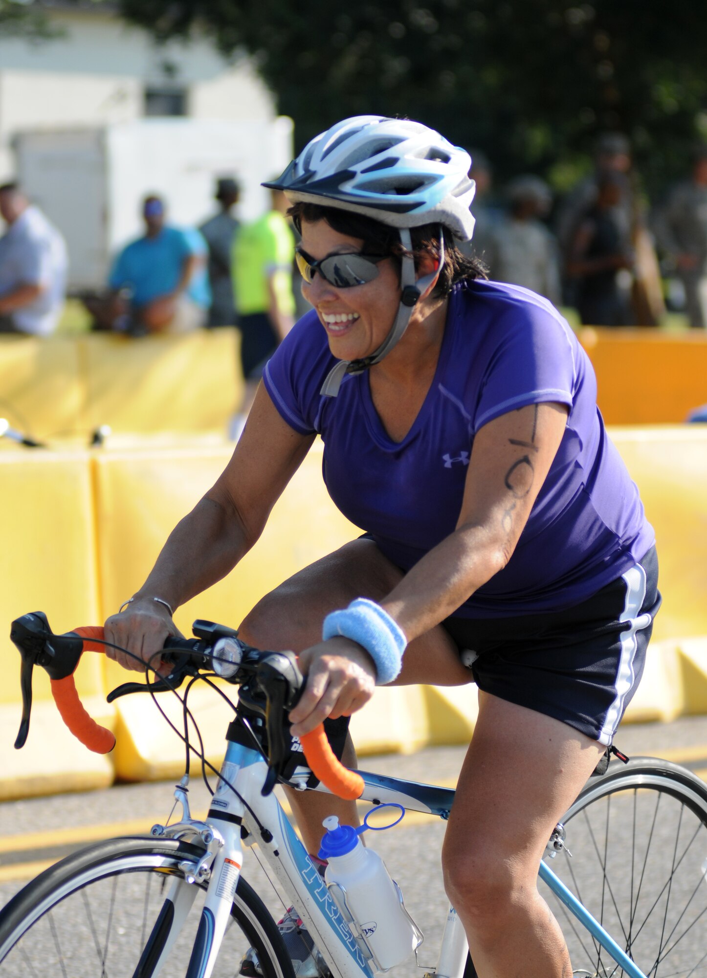 Martha Prieto-Moreno, 81st Medical Group, cycles around the 9-mile bike course during Keesler's mini-triathlon Sept. 13, 2013, at Keesler Air Force Base, Miss.  The event also included a 2-mile run and a 200-yard swim.  (U.S. Air Force photo by Kemberly Groue)
