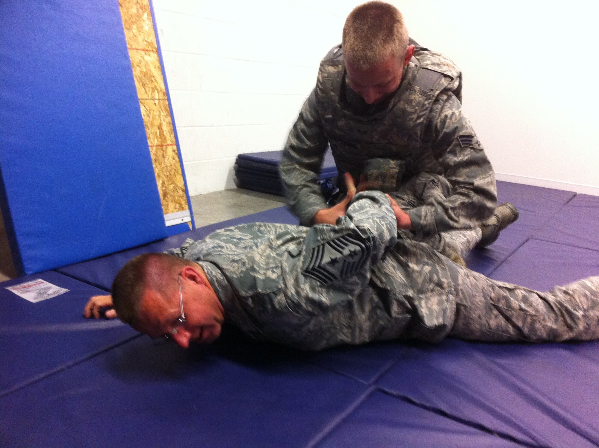 22 Air Force Command Chief Master Sgt. Steven Larwood is taken down by Senior Airman Matthew Redepenning, 934th Security Forces Squadron, as part of the SFS  non-compliant handcuffing training.  The chief spent the September UTA participating in UTA activities with 934th AW Airmen. (Courtesy Photo).
