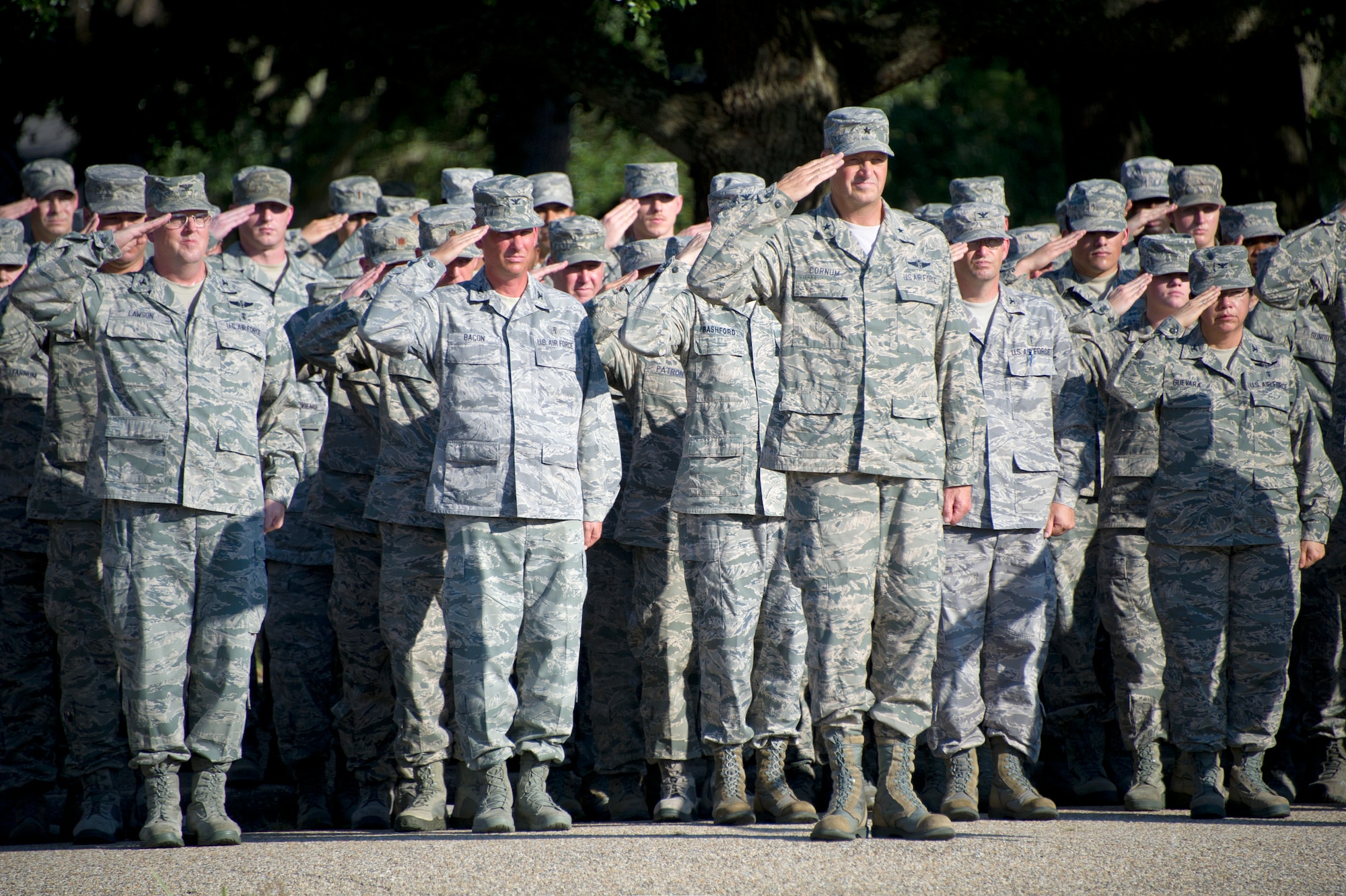 Brig. General Kory Cornum, 81st Medical Group commander, renders a salute with his group as the U.S. flag is lowered during a retreat ceremony Sept. 11, 2013, Keesler Air Force Base, Miss. The ceremony honored those who lost their lives during the 9/11 attacks. (U.S. Air Force photo by Adam Bond)