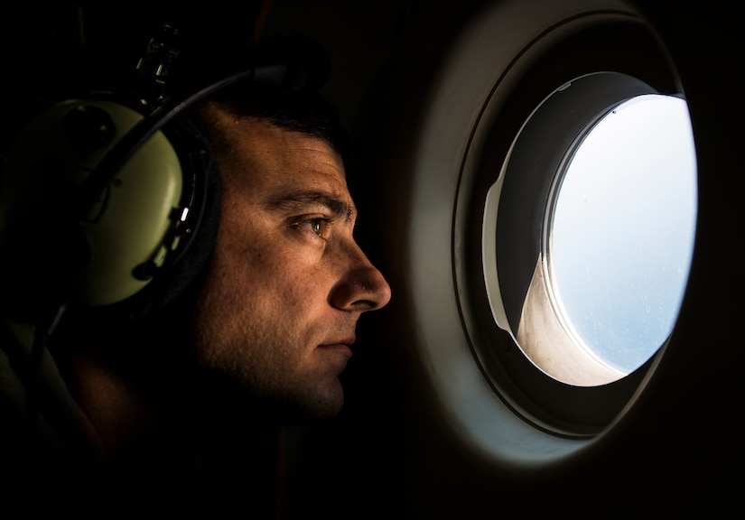TSgt. Mike Morris, 437th Airlift Wing loadmaster, looks out a port window during the final U.S. Air Force C-17 Globemaster III, P-223, flight from Long Beach, Calif., to Joint Base Charleston, S.C., Sept. 12, 2013. More than 20 years ago the first C-17 was delivered to what was then known as Charleston Air Force Base, S.C., with retired Chief Master Sgt. Bob Morris onboard as the lead loadmaster, TSgt. Mike Morris’s father. (U.S. Air Force photo/ Senior Airman Dennis Sloan)