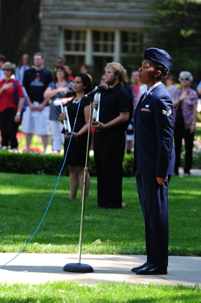 U.S. Air Force Senior Airman Nia Newton, 509th Force Support Squadron, Whiteman Air Force Base, Mo., sings the Star Spangled Banner during a 9/11 Memorial Ceremony at the University of Central Missouri in Warrensburg, Mo., Sept. 11, 2013. Both civilian and military members took the time for a moment of silence and a prayer on the 12th anniversary of the attack on America. (U.S. Air Force photo by Staff Sgt. Nick Wilson/Released)