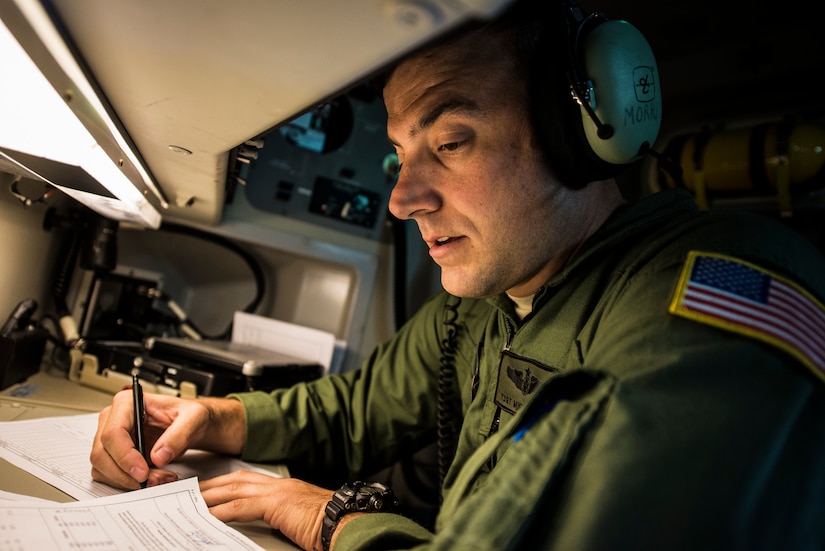 TSgt. Mike Morris, 437th Airlift Wing loadmaster, fills out flight paperwork during the final U.S. Air Force C-17 Globemaster III, P-223, flight from Long Beach, Calif., to Joint Base Charleston, S.C., Sept. 12, 2013. More than 20 years ago the first C-17 was delivered to what was then known as Charleston Air Force Base, S.C., with retired Chief Master Sgt. Bob Morris onboard as the lead loadmaster, TSgt. Mike Morris’s father. (U.S. Air Force photo/ Senior Airman Dennis Sloan)