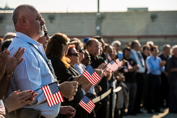Boeing employees who work on the production of the C-17 Globemaster III hold American flags in support of the military during the final U.S. Air Force C-17 Globemaster III, P-223, delivery ceremony Sept. 12, 2013, at Long Beach, Calif. The C-17 was flown from California to Joint Base Charleston, S.C., by pilots to include Gen. Paul Selva, Air Mobility Command commander, Lt. Gen. James Jackson, Air Force Reserve commander, and Lt. Gen. Stanley Clarke, Air National Guard director. This historical event comes more than 20 years after the 437th Airlift Wing and the 315th Airlift Wing took delivery of the very first C-17 to enter the Air Force inventory June 14, 1993 and marks the successful completion of C-17 production for the U.S. Air Force. (U.S. Air Force photo/ Senior Airman Dennis Sloan)