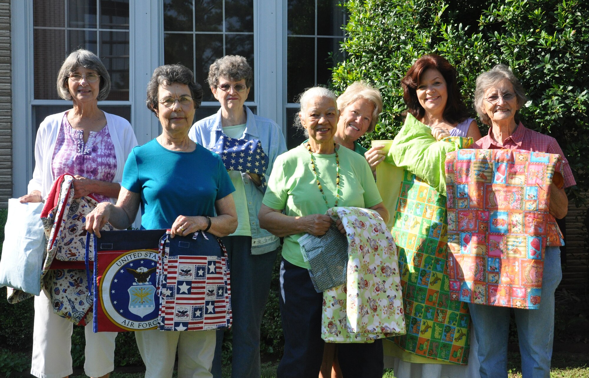 Members of the Little Rock Air Force Base sewing ministry pose for a photo before starting their day Aug. 30, 2013, at the chapel. Since January, the ministry has made more than 40 blankets, 130 sleeping caps, 40 pillows and close to 1,100 care caps for people in Arkansas and other states. (U.S. Air Force photo by Senior Airman Regina Agoha) 