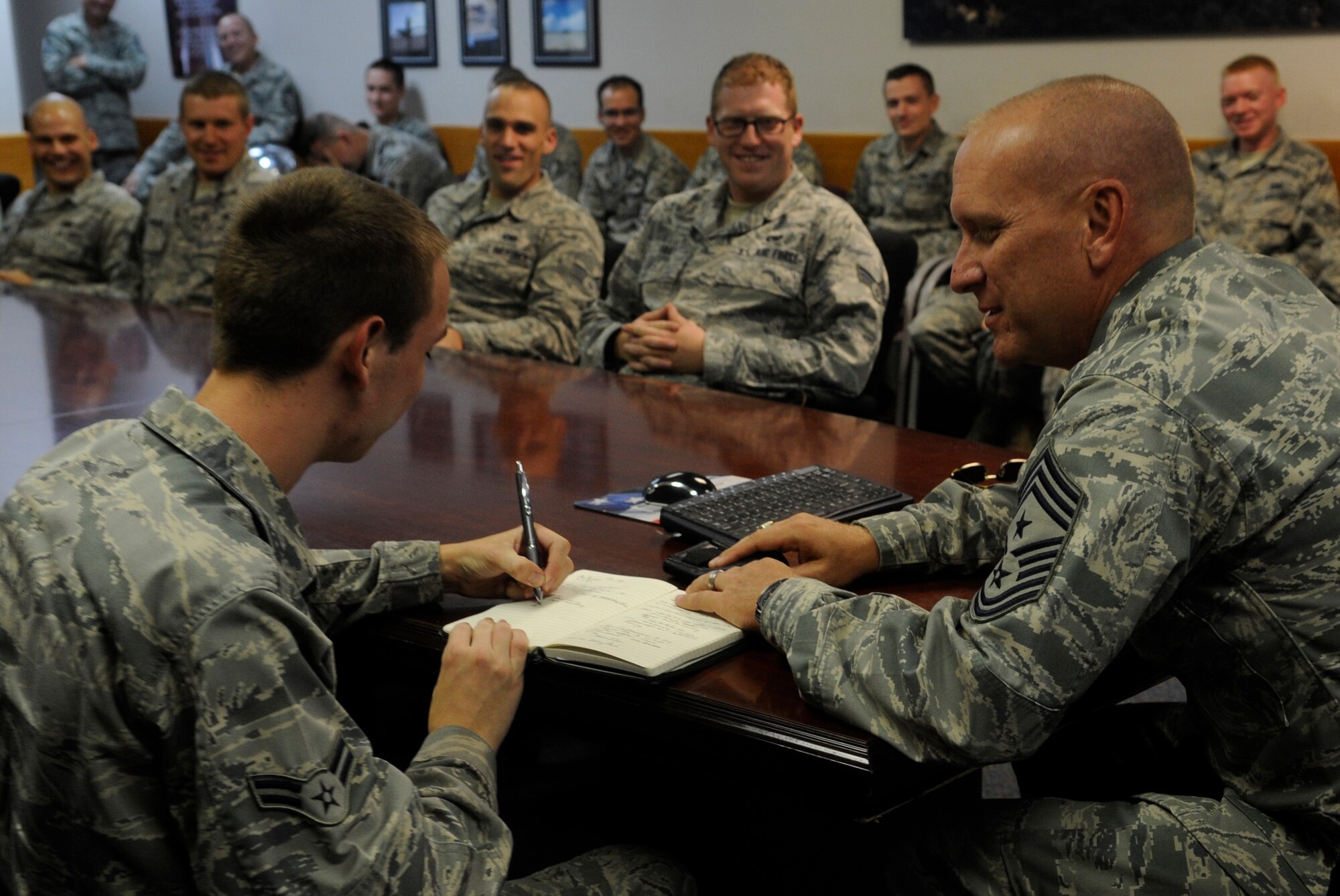 U.S. Air Force Chief Master Sgt. Brian Hornback, Air Force Global Strike Command command chief, asks Airman First Class Christopher Anderson, 509th Aircraft Maintenance Squadron crew chief, for his mother’s name and number during a visit to Whiteman Air Force Base, Mo., Sept. 6, 2013. Hornback asked Airmen why they joined the military and Anderson’s response was to make his parents proud. Hornback wanted to call the Airman’s mother to help make that goal even more of a reality. (U.S. Air Force photo by Staff Sgt. Alexandra M. Boutte/Released)