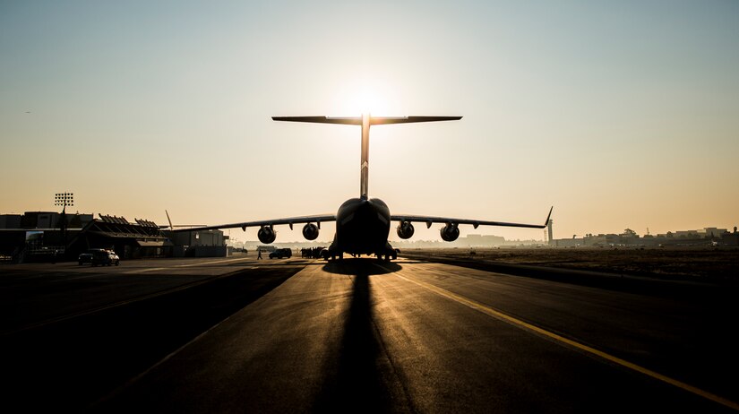 The sun rises above the final U.S. Air Force C-17 Globemaster III, P-223, as crew members arrive at the Boeing plant Sept. 12, 2013, at Long Beach, Calif. The C-17 was flown from California to Joint Base Charleston, S.C., by pilots to include Gen. Paul Selva, Air Mobility Command commander, Lt. Gen. James Jackson, Air Force Reserve commander, and Lt. Gen. Stanley Clarke, Air National Guard director. This historical event comes more than 20 years after the 437th Airlift Wing and the 315th Airlift Wing took delivery of the very first C-17 to enter the Air Force inventory June 14, 1993 and marks the successful completion of C-17 production for the U.S. Air Force. (U.S. Air Force photo/ Senior Airman Dennis Sloan)