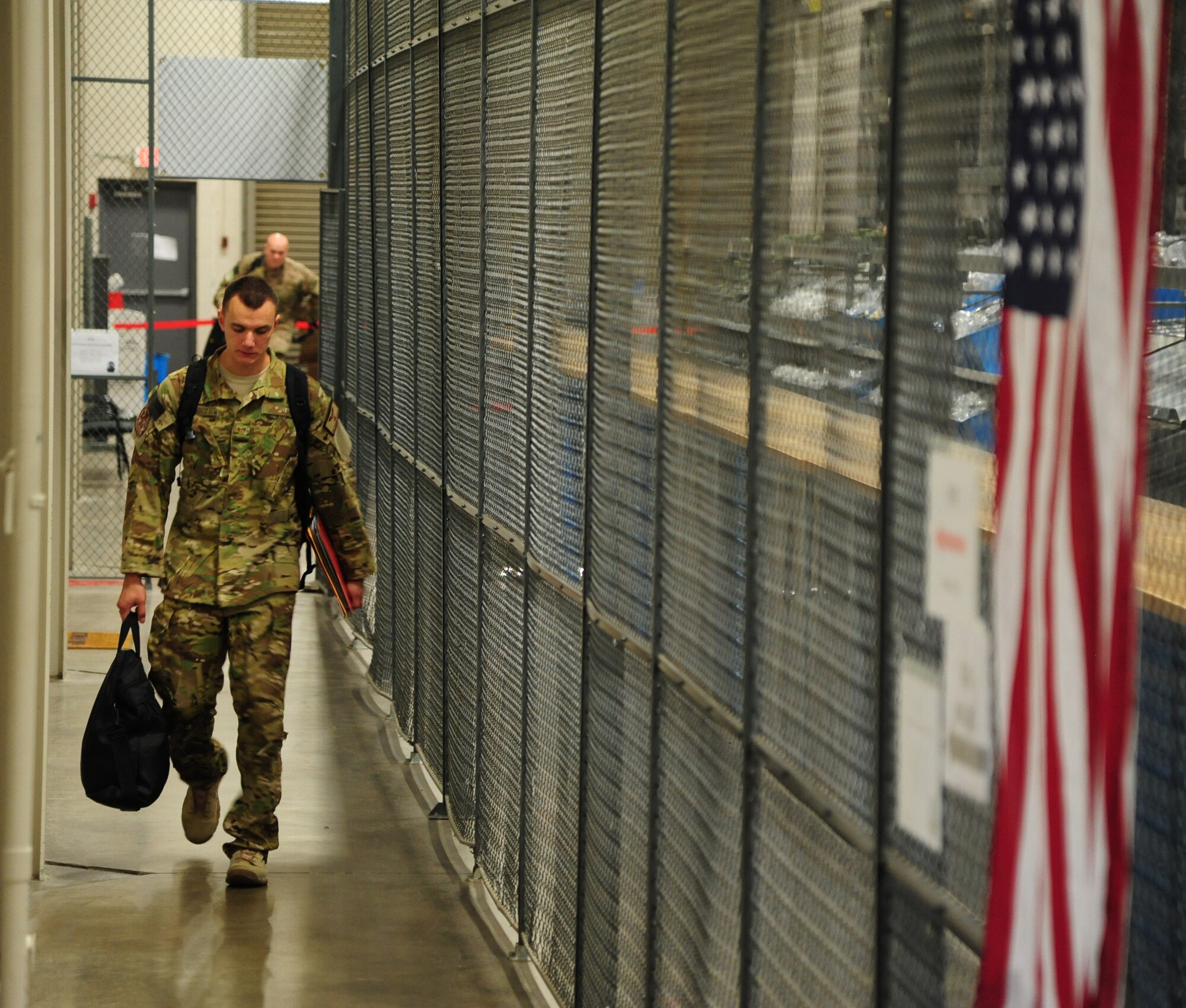 Staff Sgt. Andrew Zaragoza, a 50th Airlift Squadron flight engineer, walks to the final staging area for his deployment processing Sept. 8, 2013, at Little Rock Air Force Base, Ark. Team Little Rock Airmen specialize in combat airlift and expeditionary support down range. (U.S. Air Force photo by Senior Airman Kaylee Clark)   