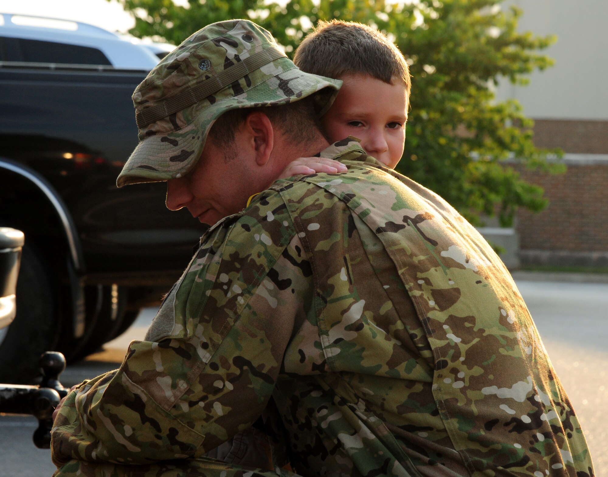 Staff Sgt. Nathan Coulter, a 50th Airlift Squadron loadmaster, hugs his son Dustin before leaving for a deployment Sept. 8, 2013, at Little Rock Air Force Base, Ark. Families and friends visited with their loved ones at the squadrons before the deployers left. (U.S. Air Force photo by Senior Airman Kaylee Clark)