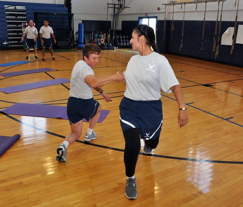 Master Sgt. Nora Martinez and Tech. Sgt. Deana Sikora, 914th Force Support Squadron, participate in an assisted exercise for a Cooper Institute Military and 1st Responder Course held at Niagara Falls Air Reserve Station, N.Y., September 9-12, 2013. This course is designed to teach Airmen how to instruct others in physical fitness through exercise and healthy living. (U.S. Air Force photo by Staff Sgt Stephanie Clark) 