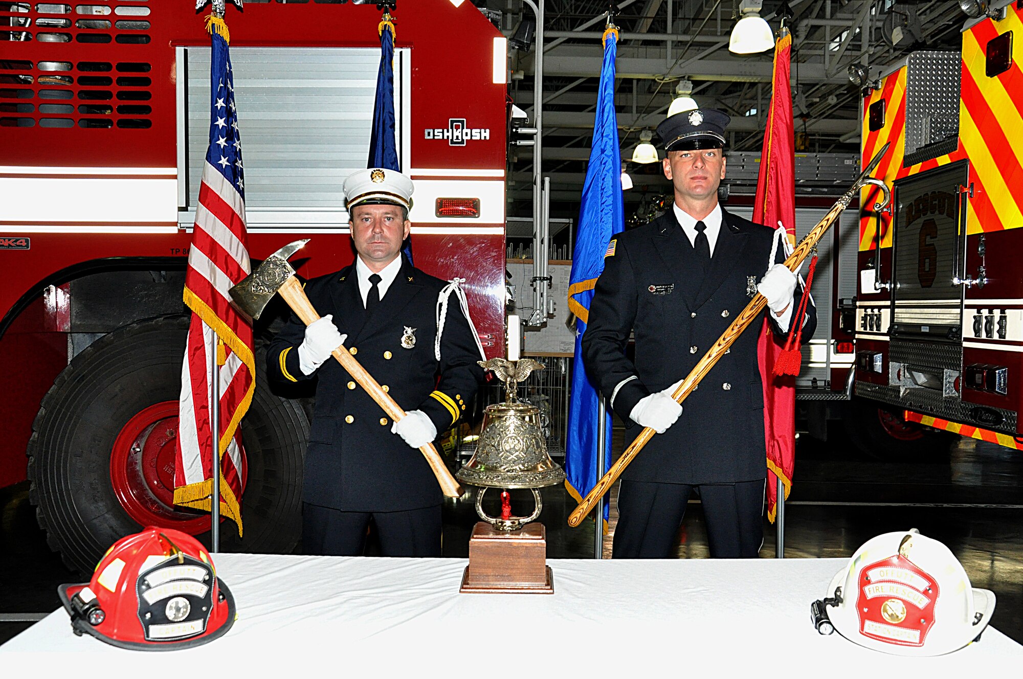 Arpad Lepper, Offutt Fire Station captain, and Brent Bergstrom, firefighter and honor guard member, pose behind a display at the Offutt Fire Station following a brief ceremony remembering the men and women who sacrificed their lives at the world trade center bombings on 9/11. (U.S. Air Force photo by D.P. Heard/Released)