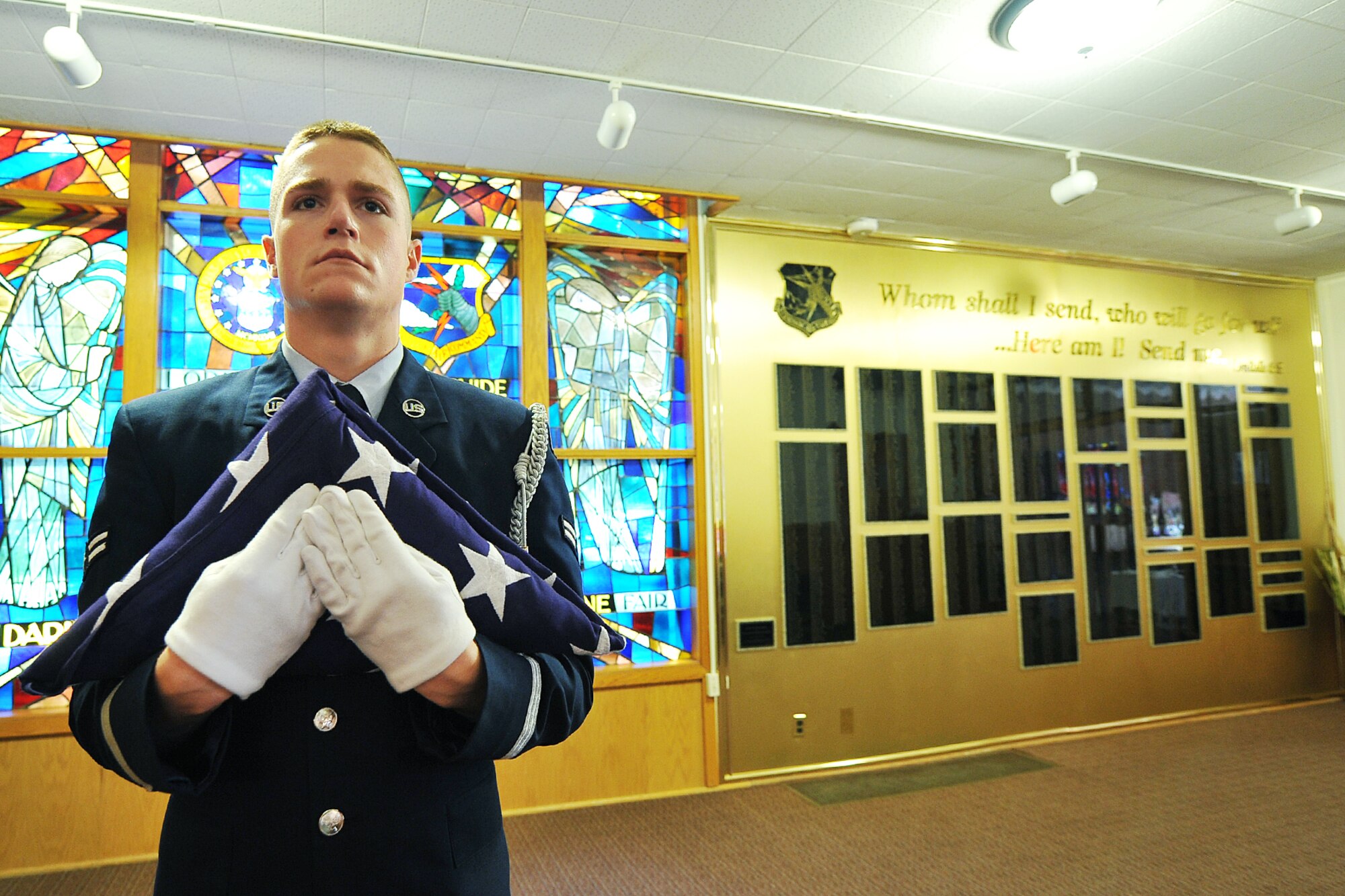 U.S. Air Force Airman 1st Class Sean Dugan, 55th Aircraft Maintenance Squadron, stands at attention before performing the flag folding ceremony during the 9/11 memorial service in the SAC Chapel on Offutt Air Force Base, Neb., Sept. 11. Memorial services were conducted all over the United States to show respect to those who died in this tragedy. (U.S. Air Force photo by Charles Haymond/Released)