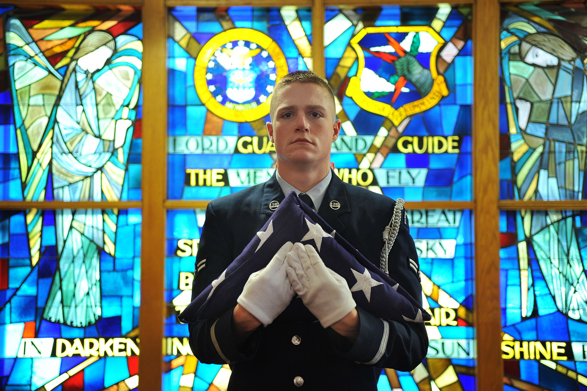 U.S. Air Force Airman 1st Class Sean Dugan, 55th Aircraft Maintenance Squadron, stands at attention before performing the flag folding ceremony during the 9/11 memorial service in the SAC Chapel on Offutt Air Force Base, Neb., Sept. 11. This memorial service marks the  anniversary of the Sept. 11, 2001, terrorist attacks when al-Qaeda operatives hijacked passenger jets and flew into the Pentagon and the World Trade Center towers in New York City. (U.S. Air Force photo by Charles Haymond/Released)