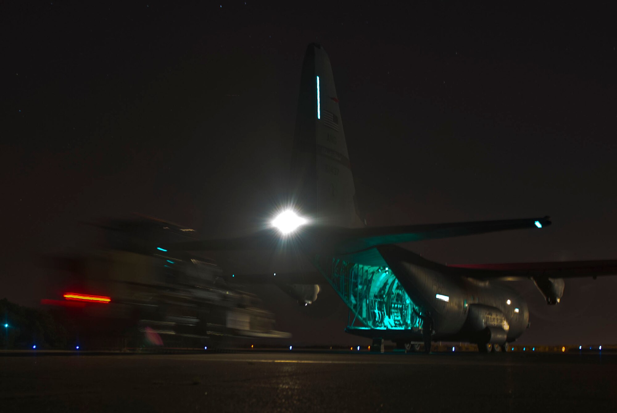QUONSET POINT AIR NATIONAL GUARD STATION, R.I. - Members of the 621st Contingency Response Wing and the 143rd Airlift Wing conduct night vision training during a low cost training here, Sept. 5, 2013. The training included loading and unloading, day and night engine running offload, night vision operations, combat offloads, maintenance familiarization, drop zone recovery, command and control, and full spectrum communications. (U.S. Air Force photo by Staff Sgt. Gustavo Gonzalez)