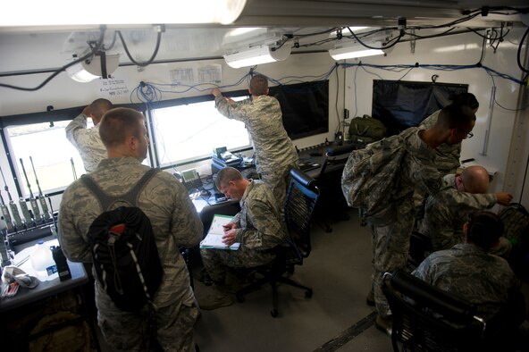 QUONSET POINT AIR NATIONAL GUARD STATION, R.I. - Members of the 621st Contingency Response Wing  check radios during a low cost training here, Sept. 4, 2013. The training included loading and unloading, day and night engine running offload, night vision operations, combat offloads, maintenance familiarization, drop zone recovery, command and control, and full spectrum communications. (U.S. Air Force photo by Staff Sgt. Gustavo Gonzalez)