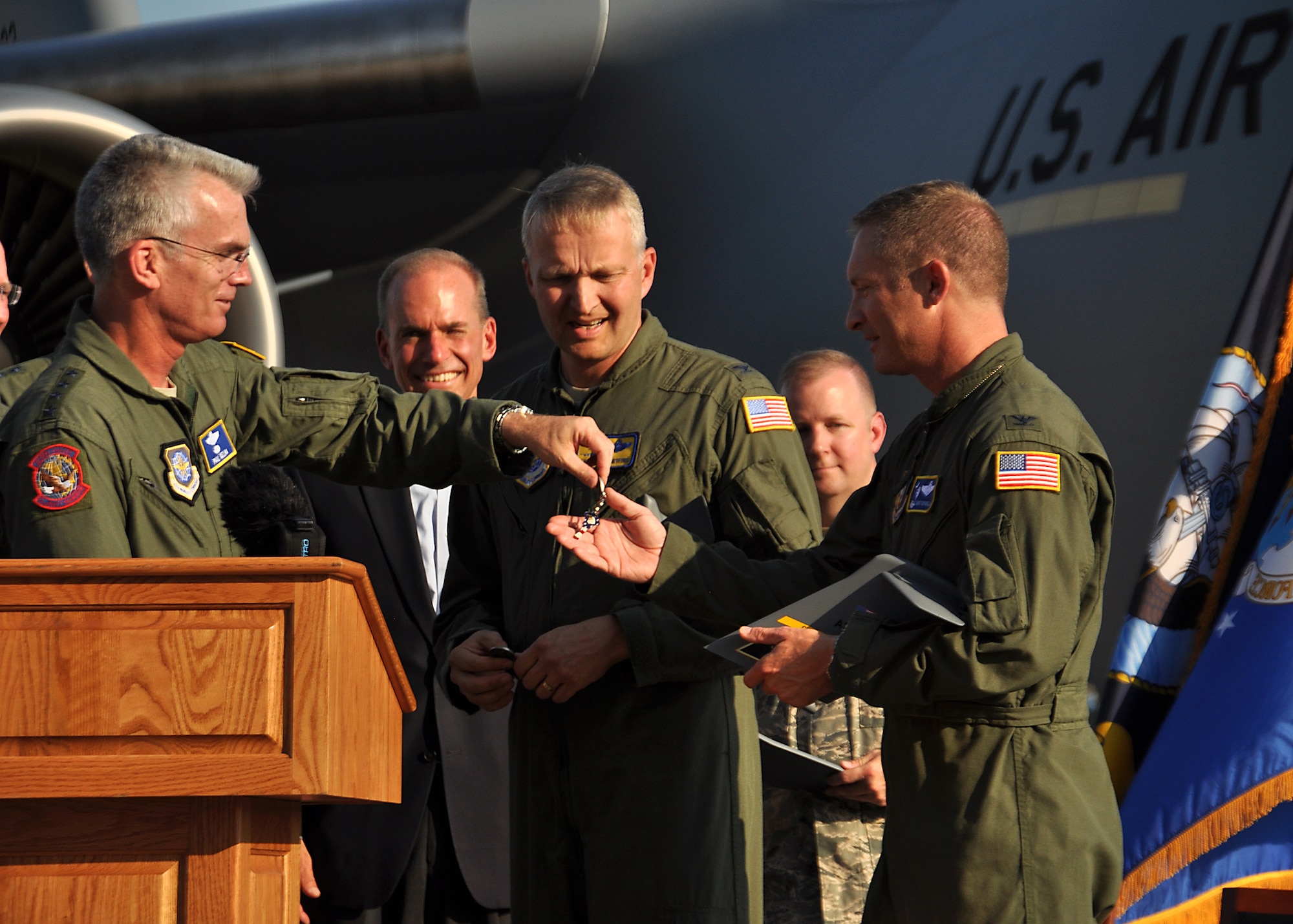 Gen. Paul Selva, Air Mobility Command commander, hands the ceremonial "keys" to the Air Force's final C-17 to Col. James Fontanella, 315th Airlift Wing Commander during a grand ceremony celebrating 20 years of the C-17 Globemaster III and the final Air Force C-17 out of the Boeing factory. (U.S. Air Force photo / Michael Dukes)
