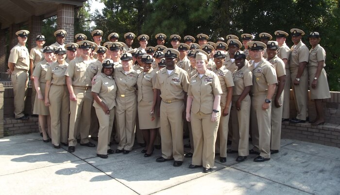 Master, senior and chief petty officers surround the new members of the LowCountry’s Chief Petty Officer’s mess, shortly after the pinning ceremony marking the transition from E-6 to chief petty officer Sept. 13, 2013, at the All Saints Chapel on Joint Base Charleston – Weapons Station. (U.S. Navy photo/Eric Sesit) 