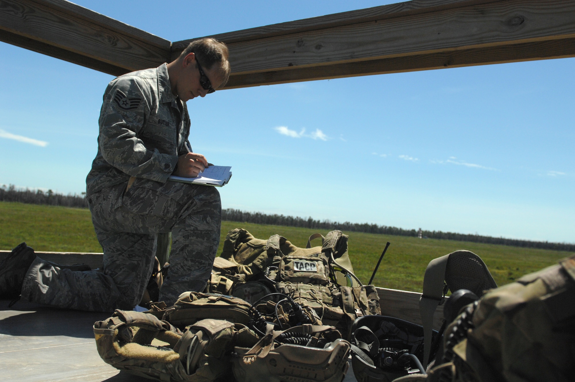 U.S. Air Force Staff Sgt. Jonathan Butler, 15th Air Support Operations Squadron joint terminal attack controller, prepares the team’s equipment at the Dare County Bomb Range in Stumpy Point, N.C., Aug. 26, 2013.  Members of the 336th Fighter Squadron and the 15th ASOS and received training to maintain their currencies while on the range.  (U.S. Air Force photo by Airman 1st Class Brittain Crolley)