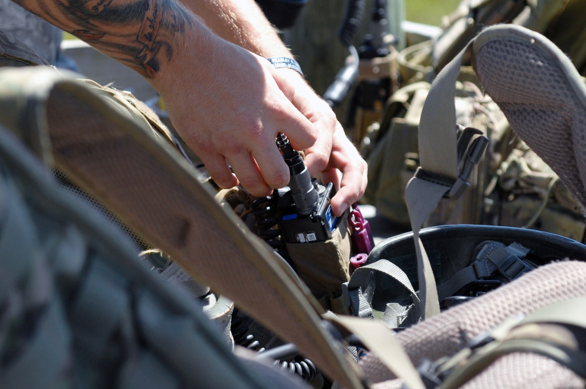 An Airman assigned to the 15th Air Support Operations Squadron, Fort Stewart, Ga., prepares his equipment before conducting joint terminal attack controller (JTAC) training at the Dare County Bomb Range in Stumpy Point, N.C., Aug. 26, 2013.  JTACs coordinated and directed multiple F-15E Strike Eagles assigned to the 336th Fighter Squadron to perform close air support training missions.  (U.S. Air Force photo by Airman 1st Class Brittain Crolley)