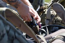 An Airman assigned to the 15th Air Support Operations Squadron, Fort Stewart, Ga., prepares his equipment before conducting joint terminal attack controller (JTAC) training at the Dare County Bomb Range in Stumpy Point, N.C., Aug. 26, 2013.  JTACs coordinated and directed multiple F-15E Strike Eagles assigned to the 336th Fighter Squadron to perform close air support training missions.  (U.S. Air Force photo by Airman 1st Class Brittain Crolley)
