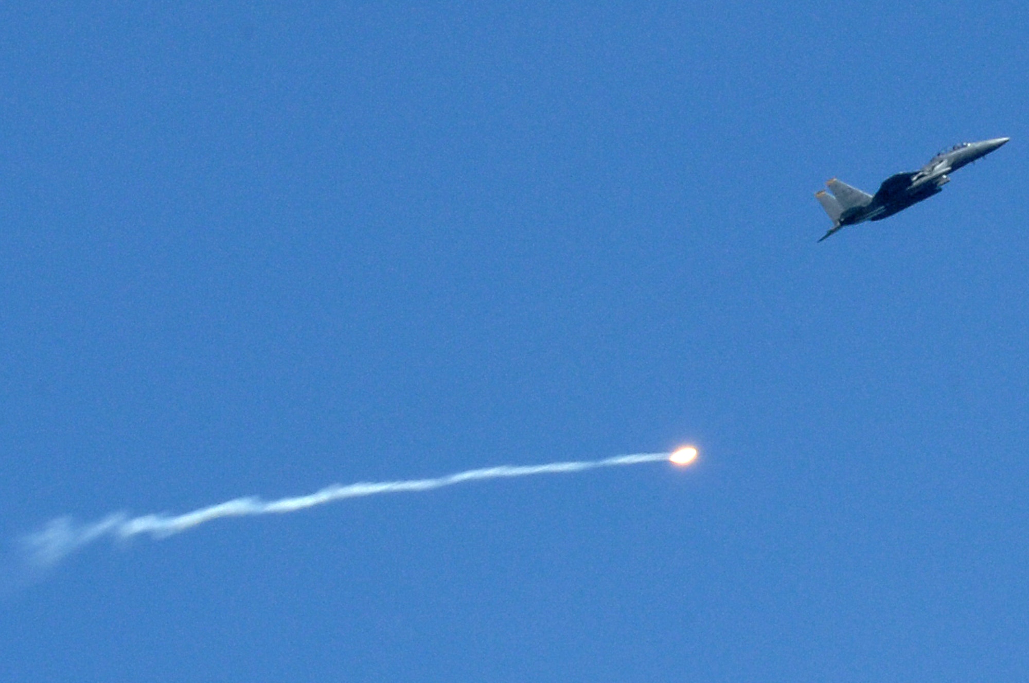A pilot assigned to the 336th Fighter Squadron, Seymour Johnson Air Force Base, N.C., launches a training ordnance at the Dare County Bomb Range in Stumpy Point, N.C., Aug. 26, 2013.  The weeklong training consisted of F-15E Strike Eagle pilots dropping multiple practice bombs on simulated targets in coordination with joint terminal attack controllers.  (U.S. Air Force photo by Airman 1st Class Brittain Crolley)
